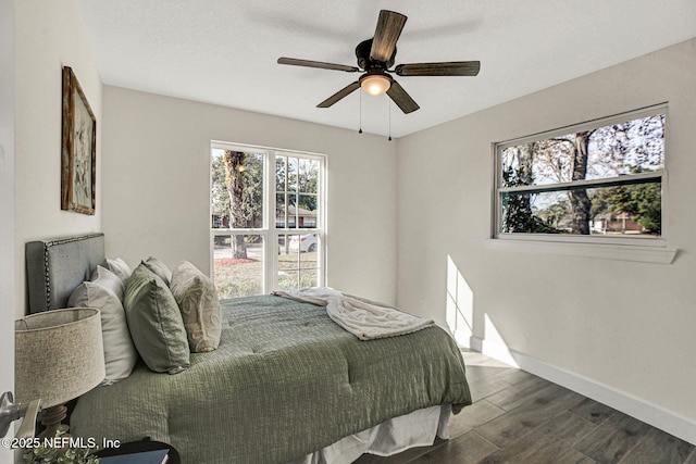 bedroom featuring dark hardwood / wood-style floors and ceiling fan