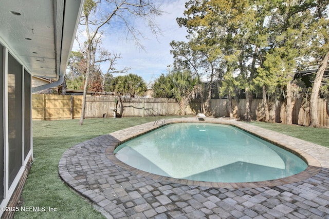 view of swimming pool with a lawn