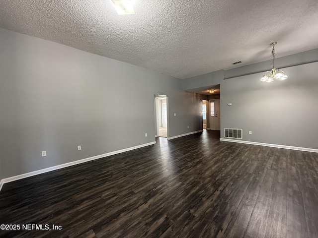 unfurnished room featuring dark hardwood / wood-style floors and a textured ceiling