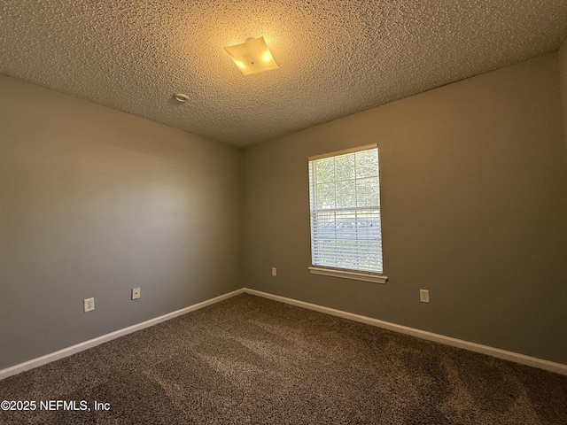 carpeted spare room featuring a textured ceiling