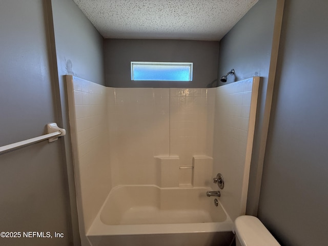 bathroom featuring washtub / shower combination and toilet