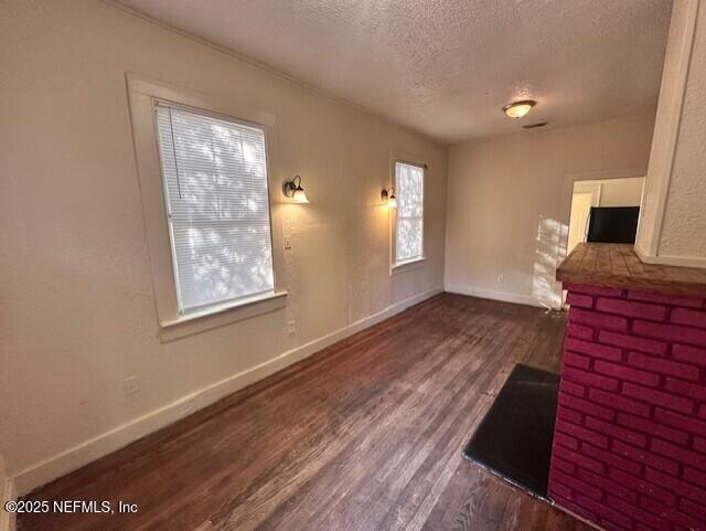 living room featuring dark hardwood / wood-style floors and a textured ceiling