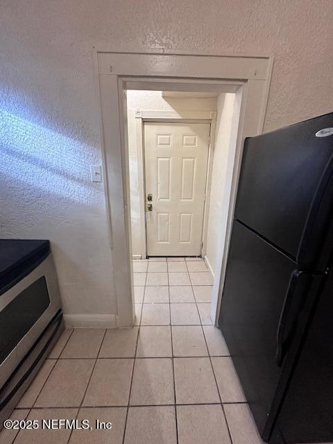 entryway with light tile patterned floors