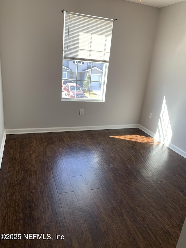 spare room featuring dark hardwood / wood-style floors