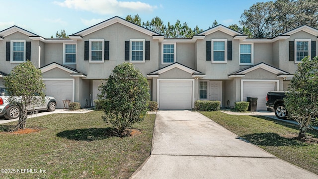 multi unit property featuring a front yard, driveway, an attached garage, and stucco siding