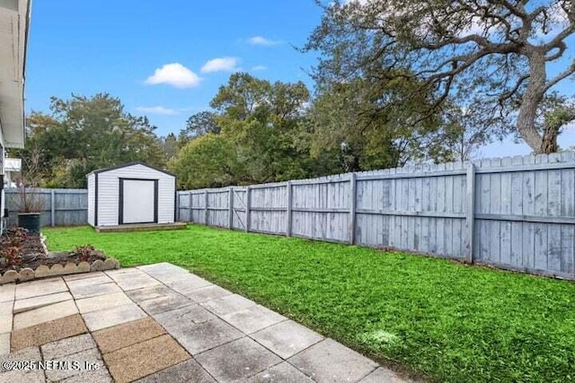 view of yard with a storage shed and a patio area