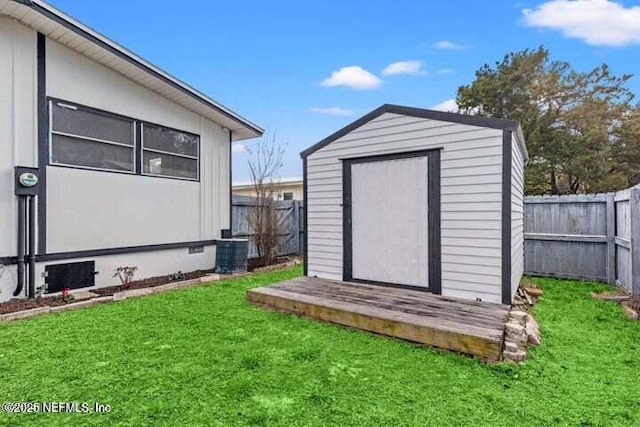 view of outbuilding featuring a yard and central AC