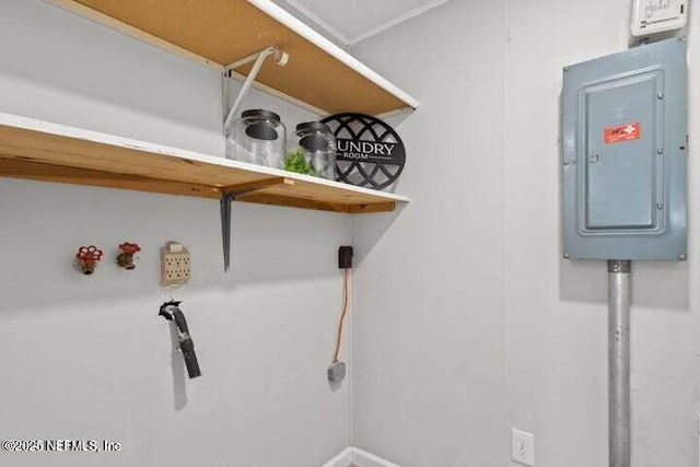 clothes washing area with electric panel