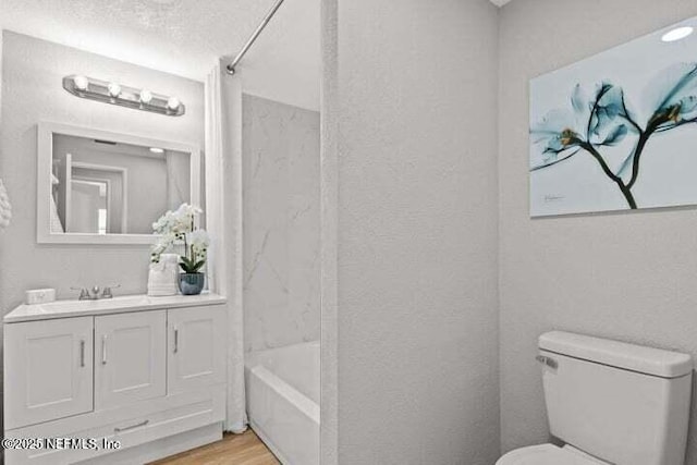 full bathroom featuring shower / tub combination, vanity, toilet, and wood-type flooring