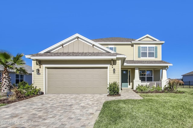 85248 Berryessa Way, Fernandina Beach, FL 32034 - view of front facade with a garage, a front yard, and a porch