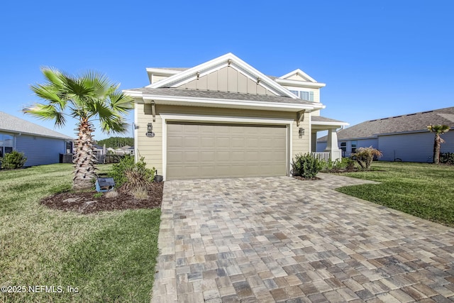85248 Berryessa Way, Fernandina Beach, FL 32034 - view of front of house with central AC unit, a garage, and a front lawn