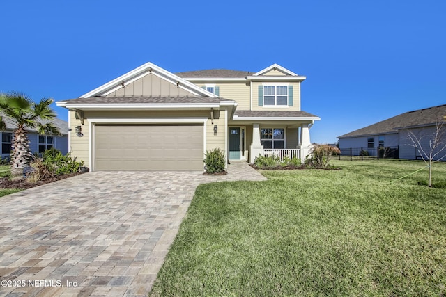 85248 Berryessa Way, Fernandina Beach, FL 32034 - view of front of property with a garage, covered porch, and a front lawn