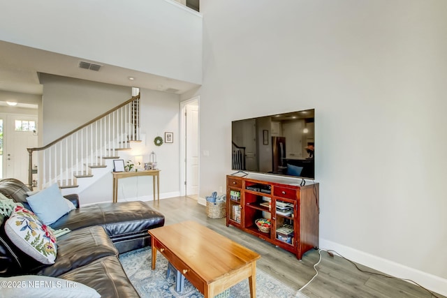 85248 Berryessa Way, Fernandina Beach, FL 32034 - living room featuring a towering ceiling and light wood-type flooring