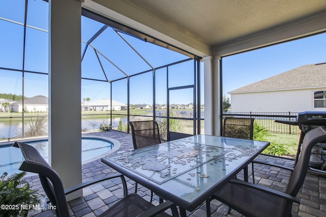 85248 Berryessa Way, Fernandina Beach, FL 32034 - view of patio / terrace with a fenced in pool, glass enclosure, and a water view