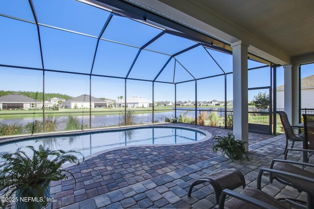 85248 Berryessa Way, Fernandina Beach, FL 32034 - view of swimming pool with a water view, a patio, and glass enclosure
