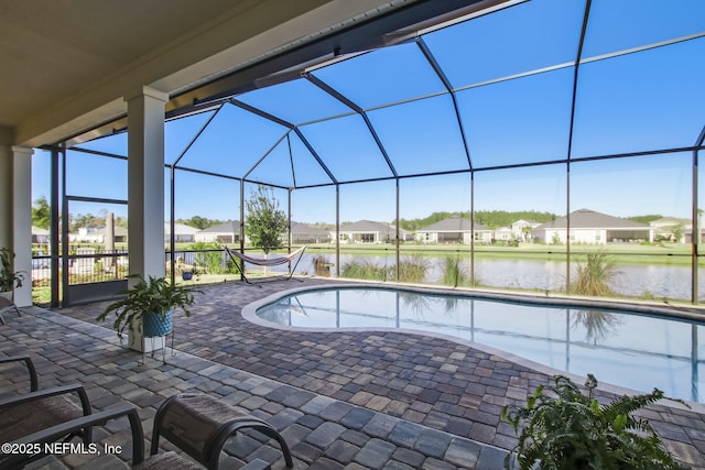 85248 Berryessa Way, Fernandina Beach, FL 32034 - view of swimming pool featuring a patio, a water view, and glass enclosure