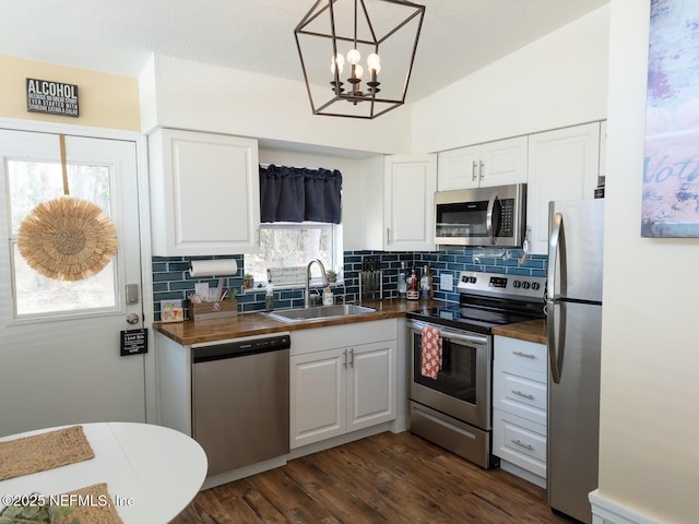 kitchen featuring tasteful backsplash, stainless steel appliances, sink, and white cabinets