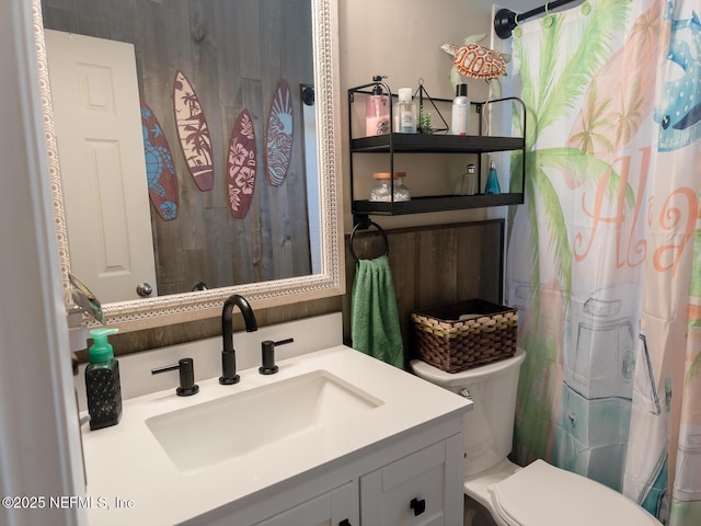 bathroom featuring walk in shower, vanity, and toilet