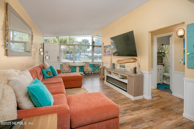 living room featuring hardwood / wood-style flooring and vaulted ceiling