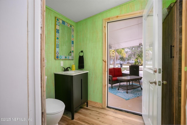 bathroom featuring hardwood / wood-style flooring, vanity, and toilet