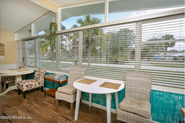 sunroom featuring plenty of natural light and vaulted ceiling