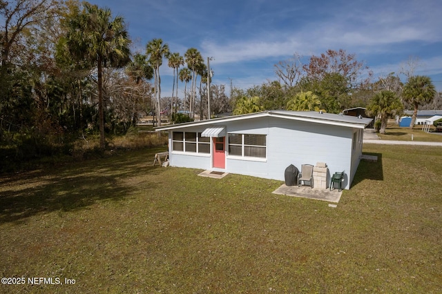 rear view of house with a yard