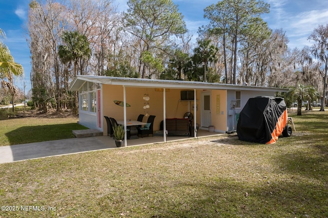 exterior space featuring a carport and a front lawn