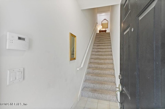 staircase featuring tile patterned flooring