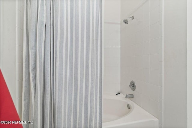 bathroom featuring shower / bath combo with shower curtain