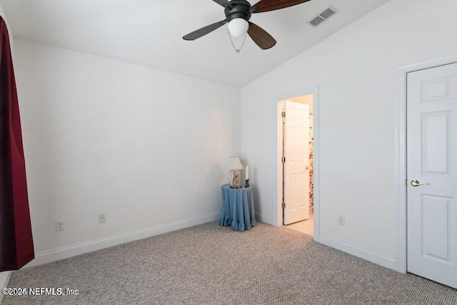 carpeted empty room featuring ceiling fan and vaulted ceiling