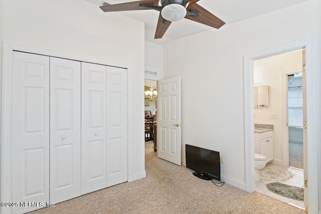 carpeted bedroom featuring a closet and ensuite bathroom