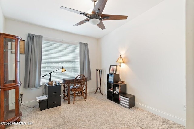 carpeted office space featuring ceiling fan