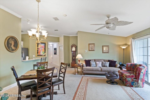 living room with ornamental molding, ceiling fan with notable chandelier, and light colored carpet