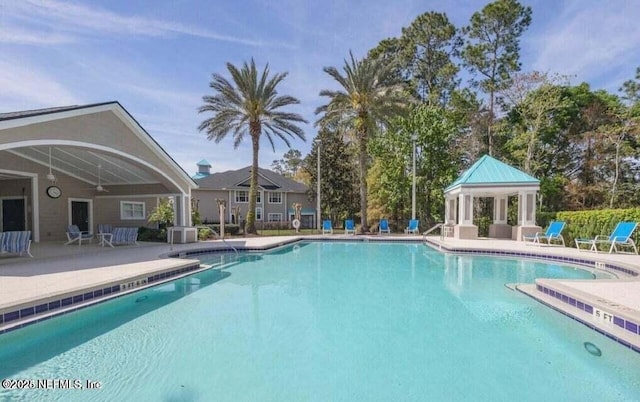 view of swimming pool with cooling unit and a patio