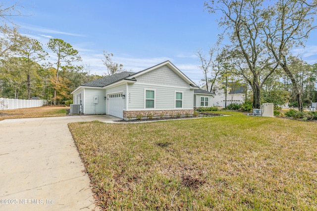 85034 Southern Creek Blvd, Fernandina Beach, FL 32034 - view of front facade featuring a garage, central AC, and a front lawn