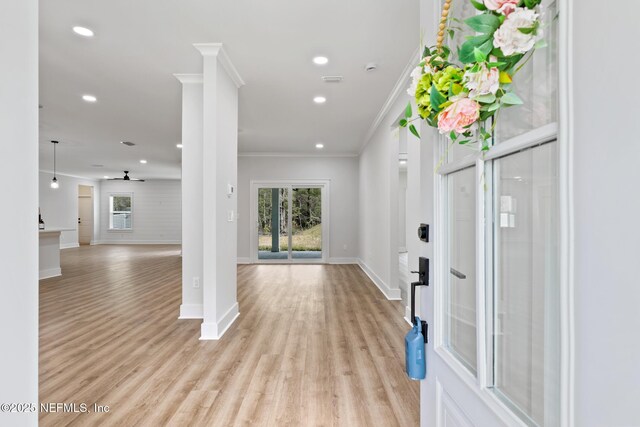 85034 Southern Creek Blvd, Fernandina Beach, FL 32034 - foyer entrance with decorative columns, ornamental molding, plenty of natural light, and light wood-type flooring