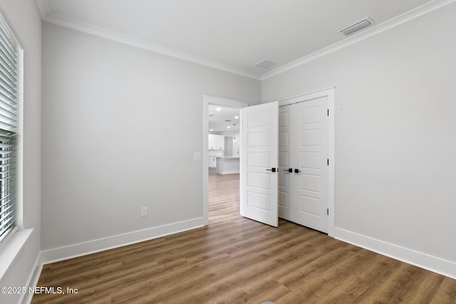 85034 Southern Creek Blvd, Fernandina Beach, FL 32034 - unfurnished bedroom featuring hardwood / wood-style flooring, ornamental molding, and a closet
