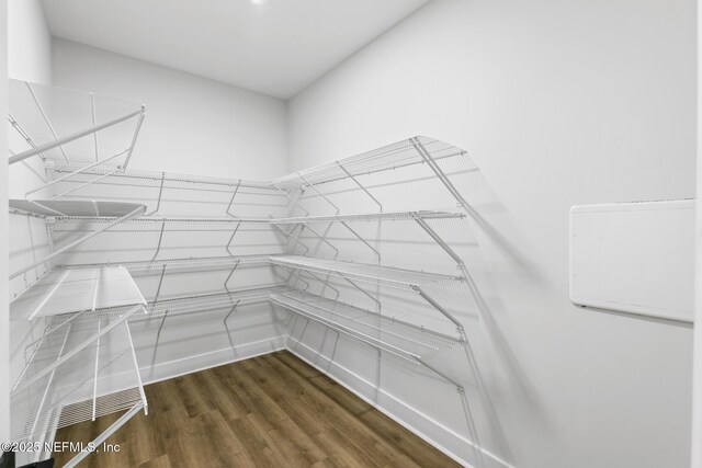 85034 Southern Creek Blvd, Fernandina Beach, FL 32034 - walk in closet with dark wood-type flooring
