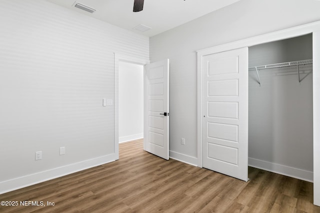 85034 Southern Creek Blvd, Fernandina Beach, FL 32034 - unfurnished bedroom featuring hardwood / wood-style floors, ceiling fan, and a closet