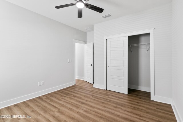 85034 Southern Creek Blvd, Fernandina Beach, FL 32034 - unfurnished bedroom with wood-type flooring, ceiling fan, and a closet