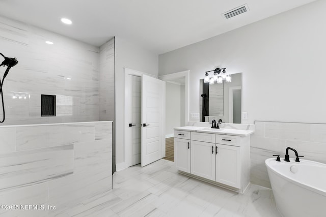 85034 Southern Creek Blvd, Fernandina Beach, FL 32034 - bathroom with vanity, a tub, and tile walls