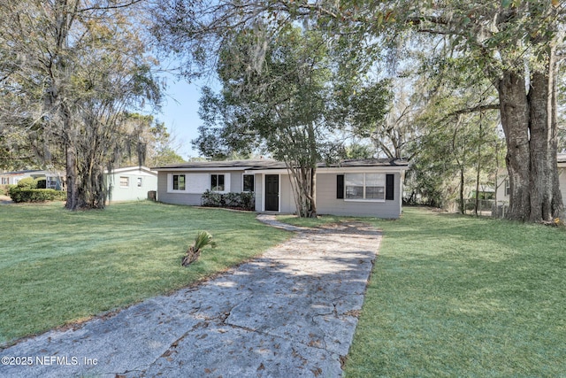 ranch-style home featuring a front yard