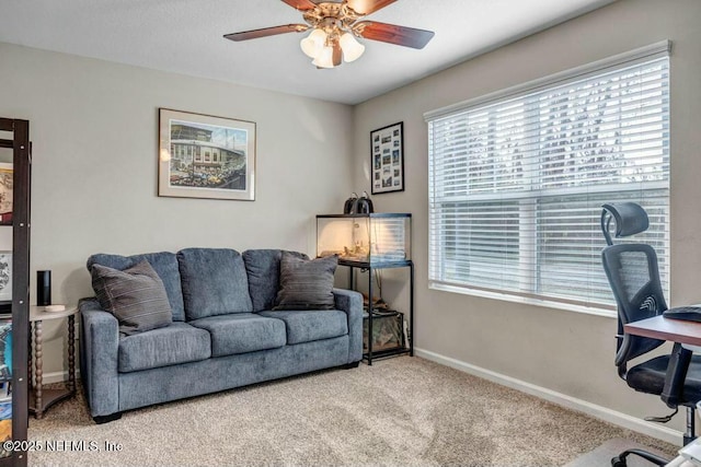 home office featuring carpet floors, ceiling fan, and baseboards