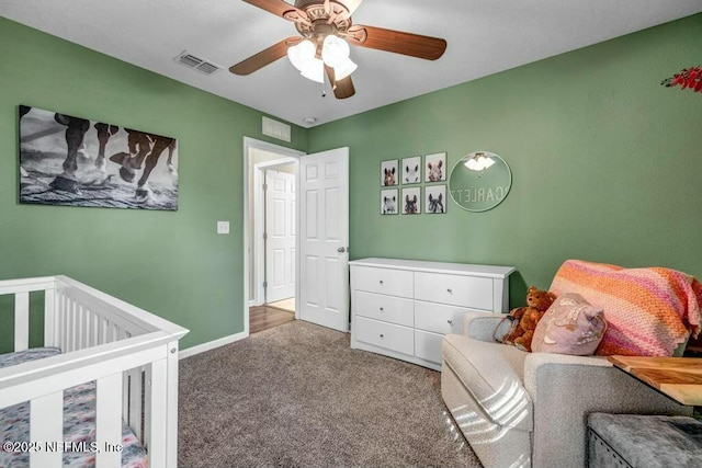 bedroom with a ceiling fan, carpet flooring, visible vents, and baseboards