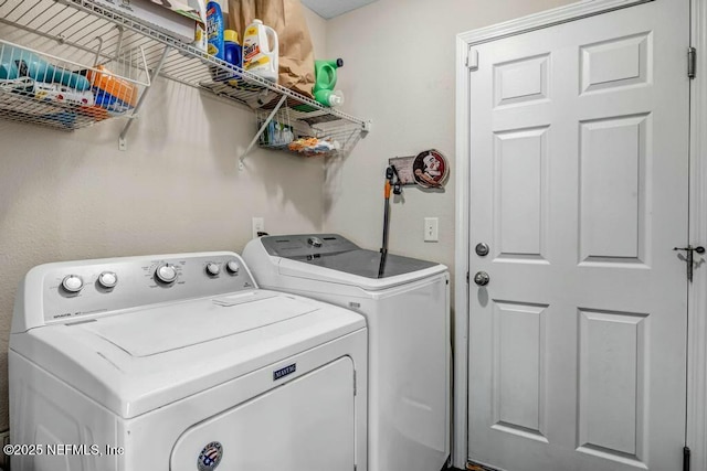 washroom featuring laundry area and washer and clothes dryer