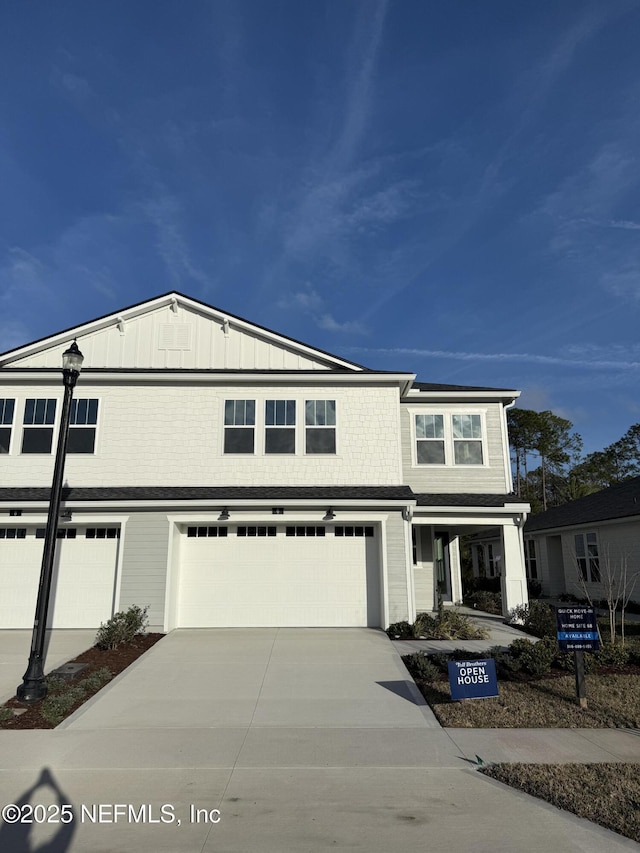 view of front of home with board and batten siding, driveway, and a garage