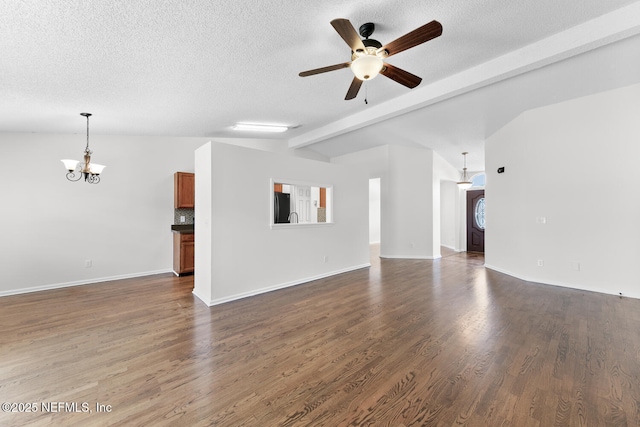 unfurnished living room with lofted ceiling with beams, ceiling fan with notable chandelier, a textured ceiling, and dark hardwood / wood-style flooring