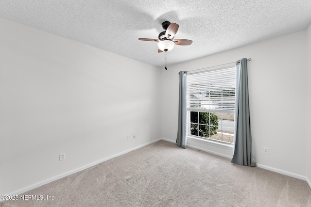 carpeted spare room with ceiling fan and a textured ceiling