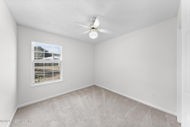 carpeted spare room with ceiling fan and a textured ceiling