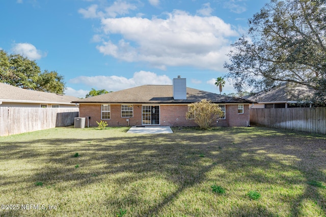 back of house with a yard, a patio area, and central air condition unit